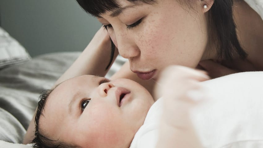 Mother kissing baby