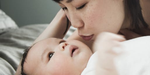 Mother kissing baby