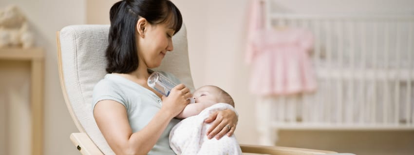 Mother bottle feeding baby