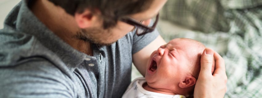 Dad comforting crying baby