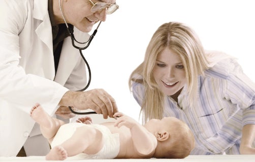 Baby being examined by doctor with mother