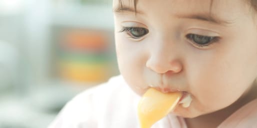 Baby eating with a spoon