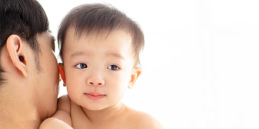 Mother holding her baby who is lactose intolerant