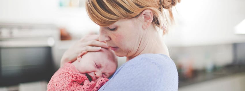 Mother comforting crying infant