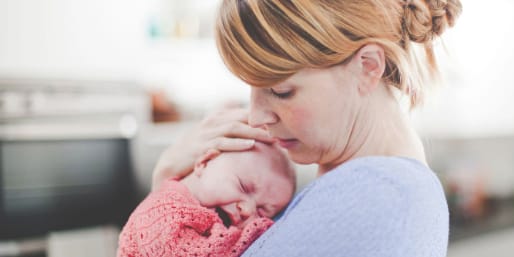 Mother comforting crying infant