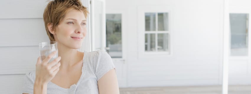 Pregnant woman drinking glass of water