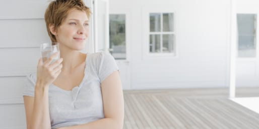 Pregnant woman drinking glass of water