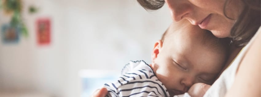 Mother holding sleeping baby