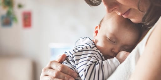 Mother holding sleeping baby