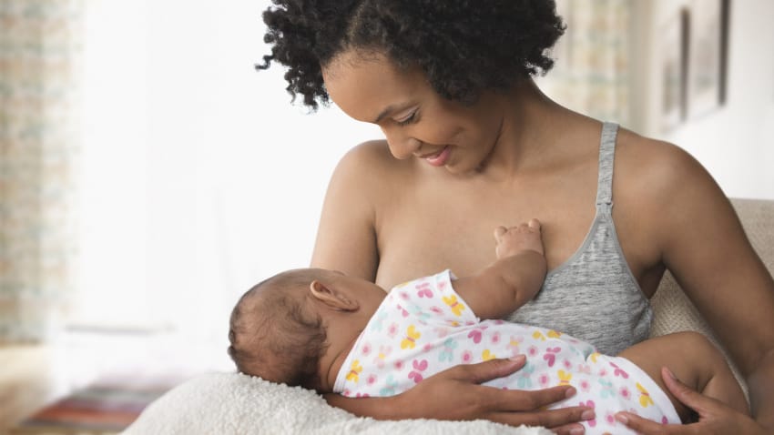 woman breastfeeding her infant