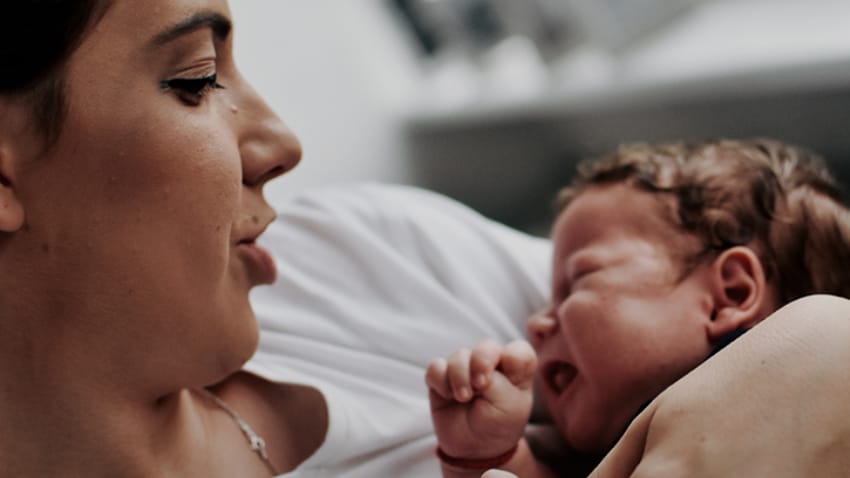 Mother soothing crying baby