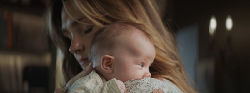 Mother holding baby to her shoulder