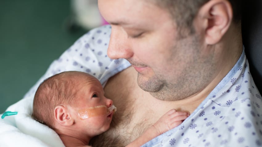 father-holding-newborn 