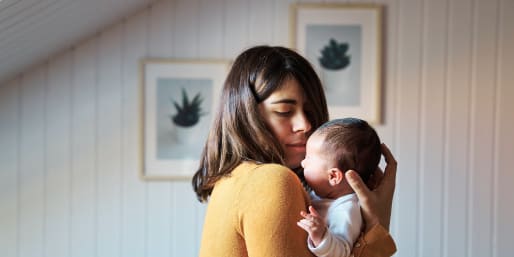 a mother experiencing feeding issues and holding her baby