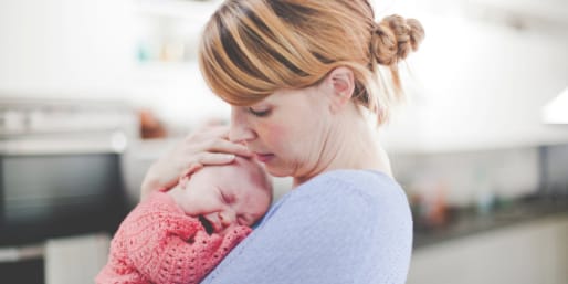 Mother holding her crying baby
