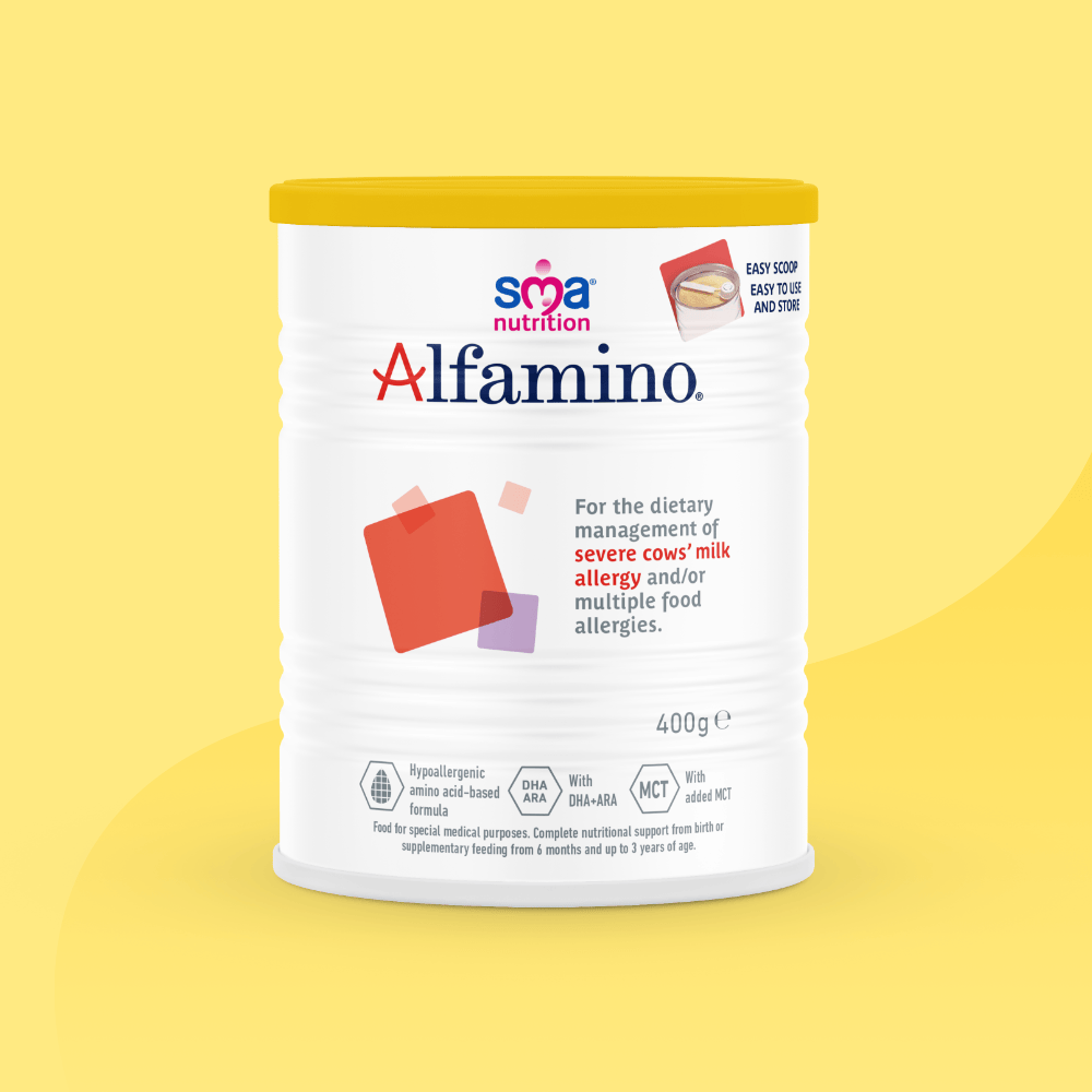 SMA Alfamino Formula Powder in a white tin with yellow lid on a yellow background.