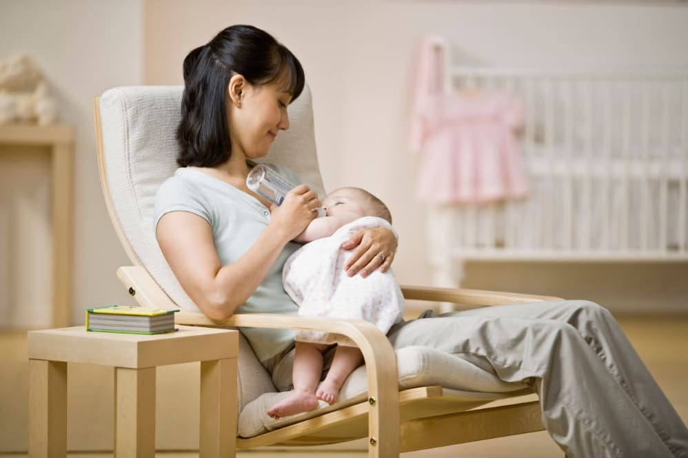 Mother bottle feeding her baby