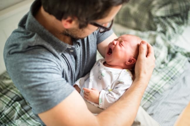 Father comforting crying infant