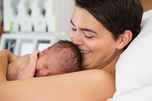 Mother holding sleeping baby