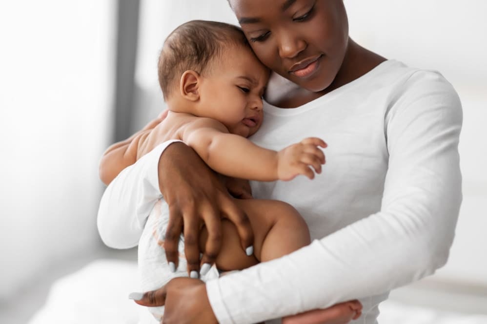 Mother holding and soothing her baby
