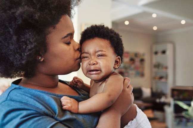 Mother comforting crying baby
