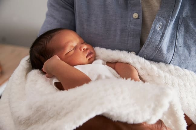 Parent holding a sleeping baby