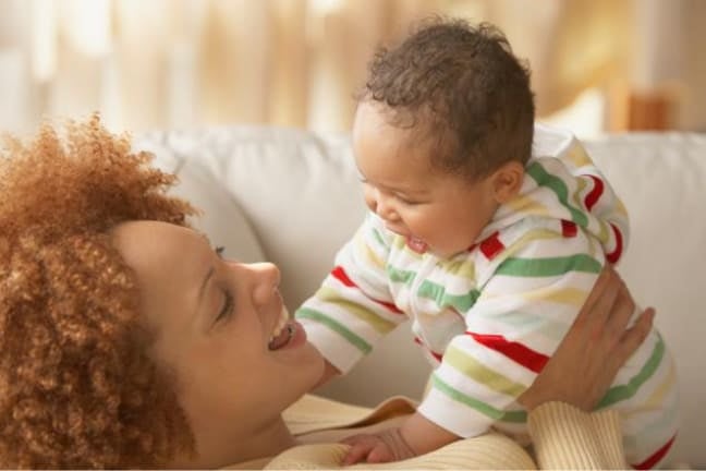 Mum and baby smiling