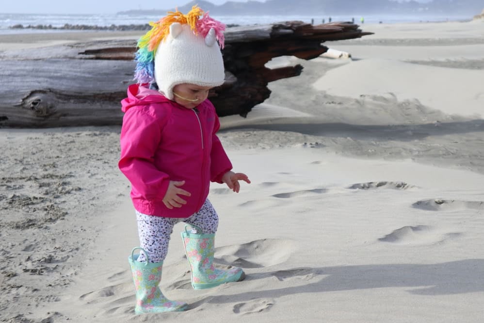 A toddler playing on the beach
