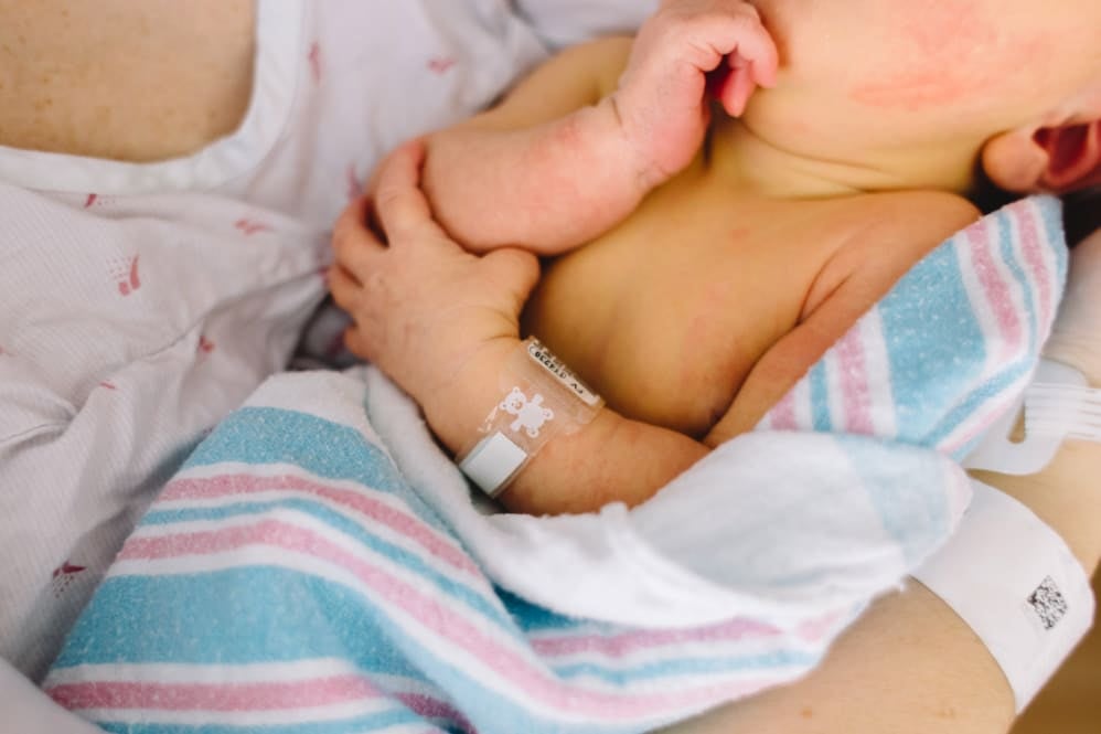 Mother holding preterm baby