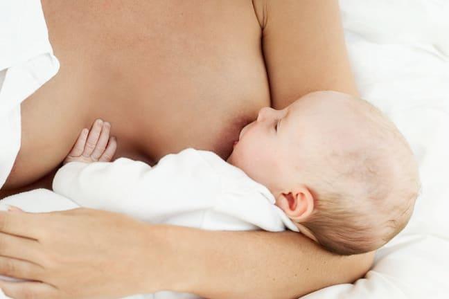 Mother cradling her baby whilst breastfeeding