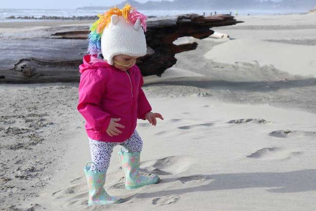 A toddler playing on the beach